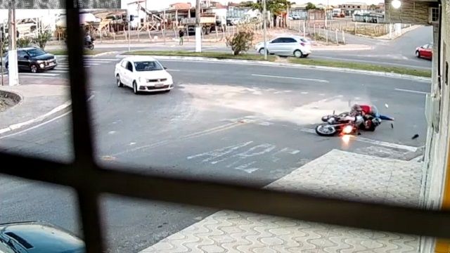 [動画0:27] すり抜けバイクさん、道路を転がる