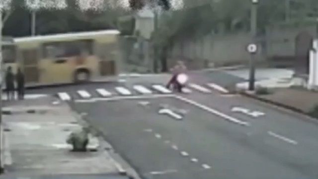 [動画0:16] 信号無視のバイク、バスの下に滑り込み轢かれる