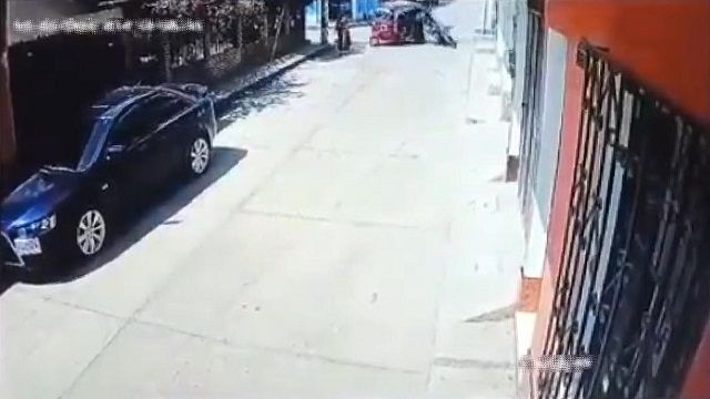 [動画0:40] バイクと衝突したトゥクトゥクが横転、歩いていた女性が下敷きに