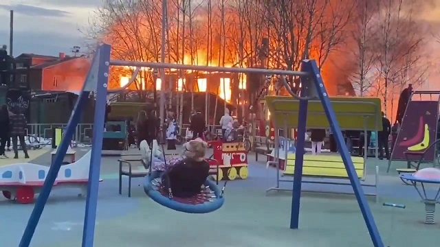 [動画0:21] 火災を目の前にして遊具で遊び続ける母娘